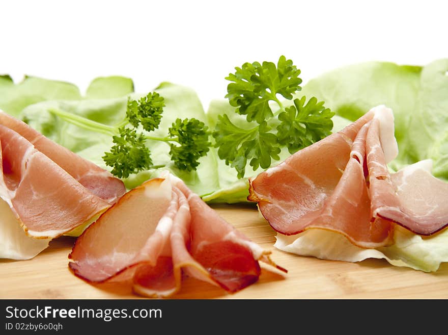 Sausage plate with raw ham and parsley