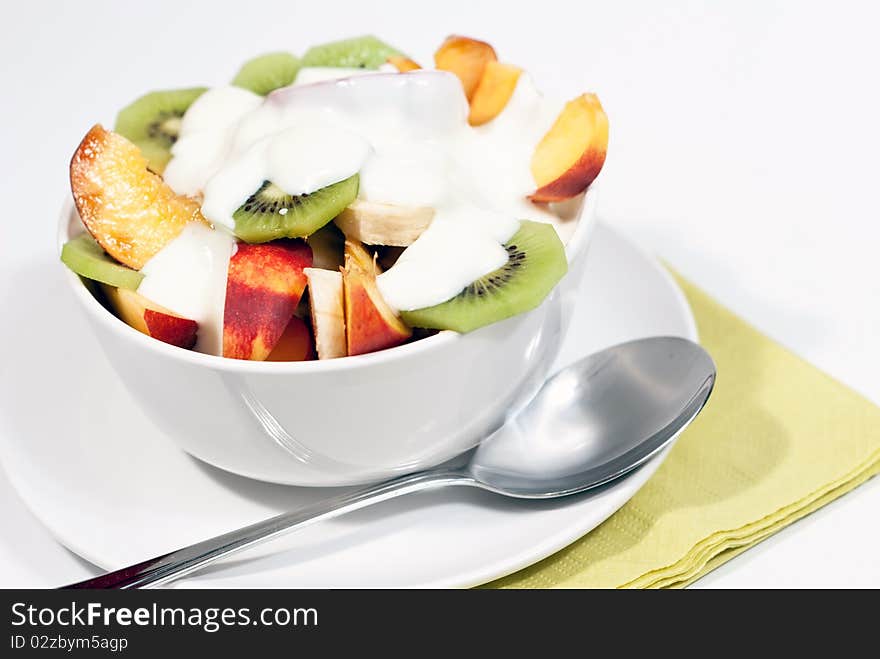 White bowl of fresh fruit and yogurt. White bowl of fresh fruit and yogurt