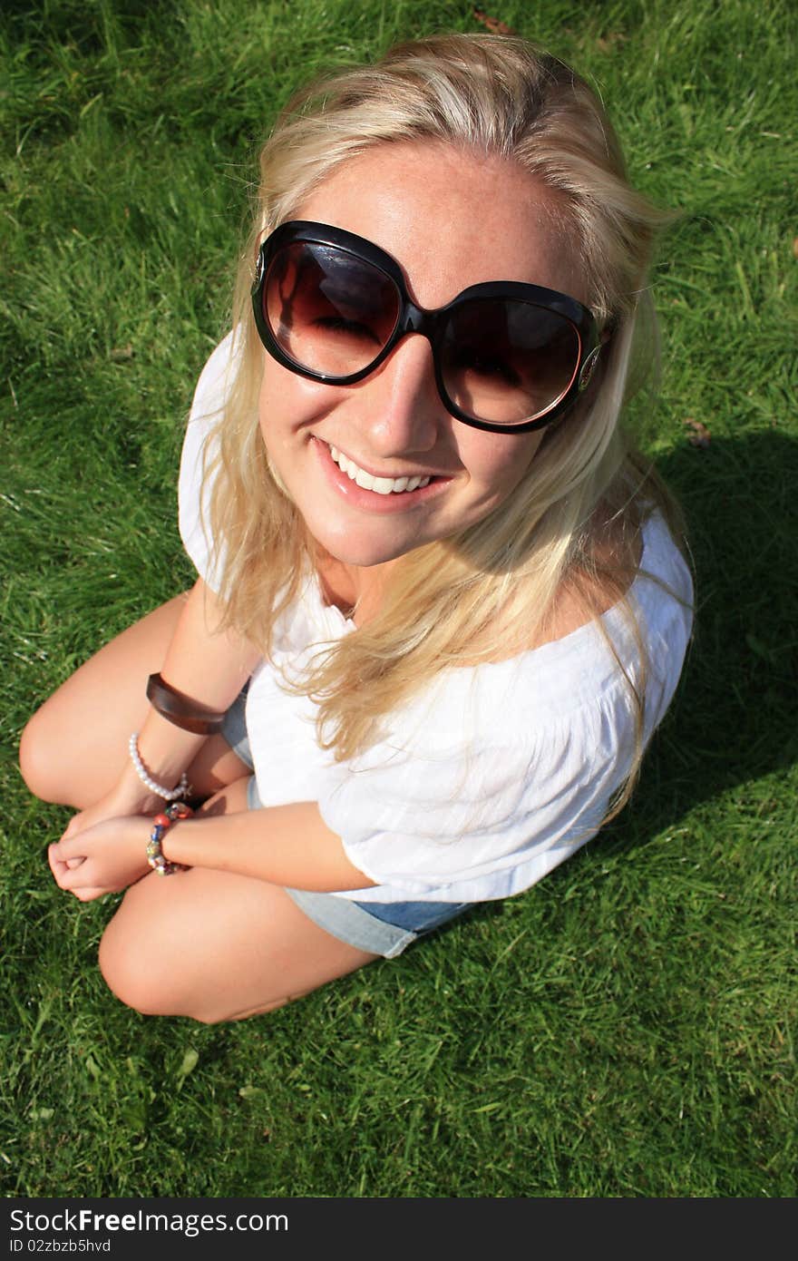 A young lady is enjoying the nice day at the park. A young lady is enjoying the nice day at the park