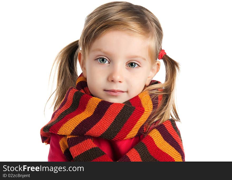 Portrait of a cute little girl in a striped scarf. Portrait of a cute little girl in a striped scarf