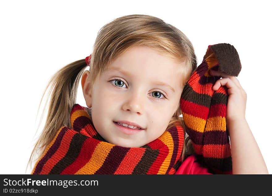 Portrait of a cute little girl in a striped scarf