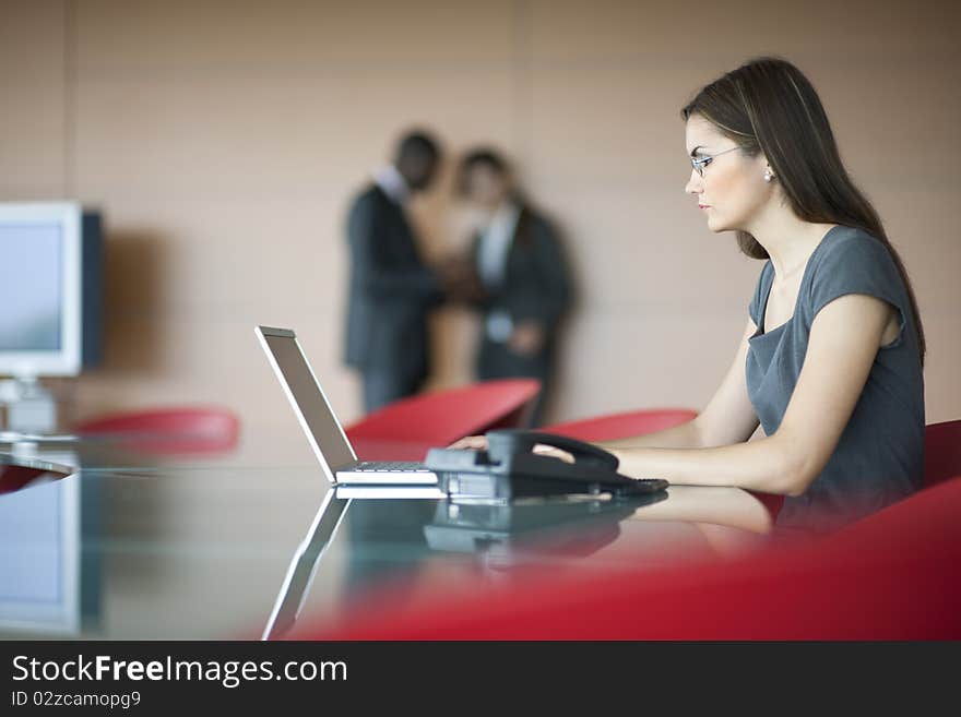 Portrait of a young businesswoman, colleagues on backgrounds. Portrait of a young businesswoman, colleagues on backgrounds