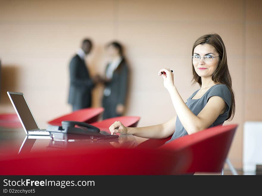 Portrait of a young businesswoman, colleagues on backgrounds. Portrait of a young businesswoman, colleagues on backgrounds