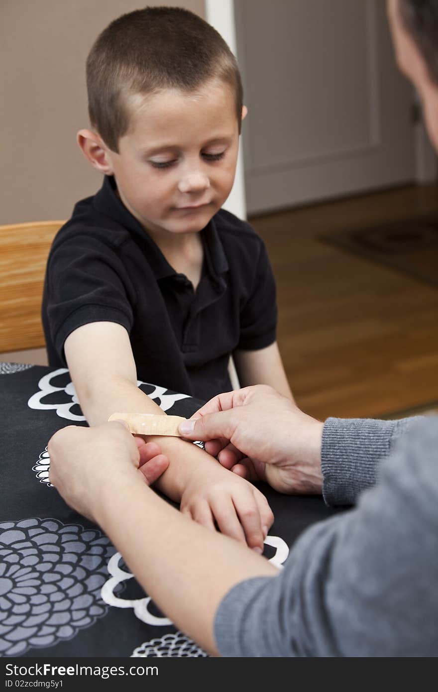 Man puting Band-Aid on sons arm