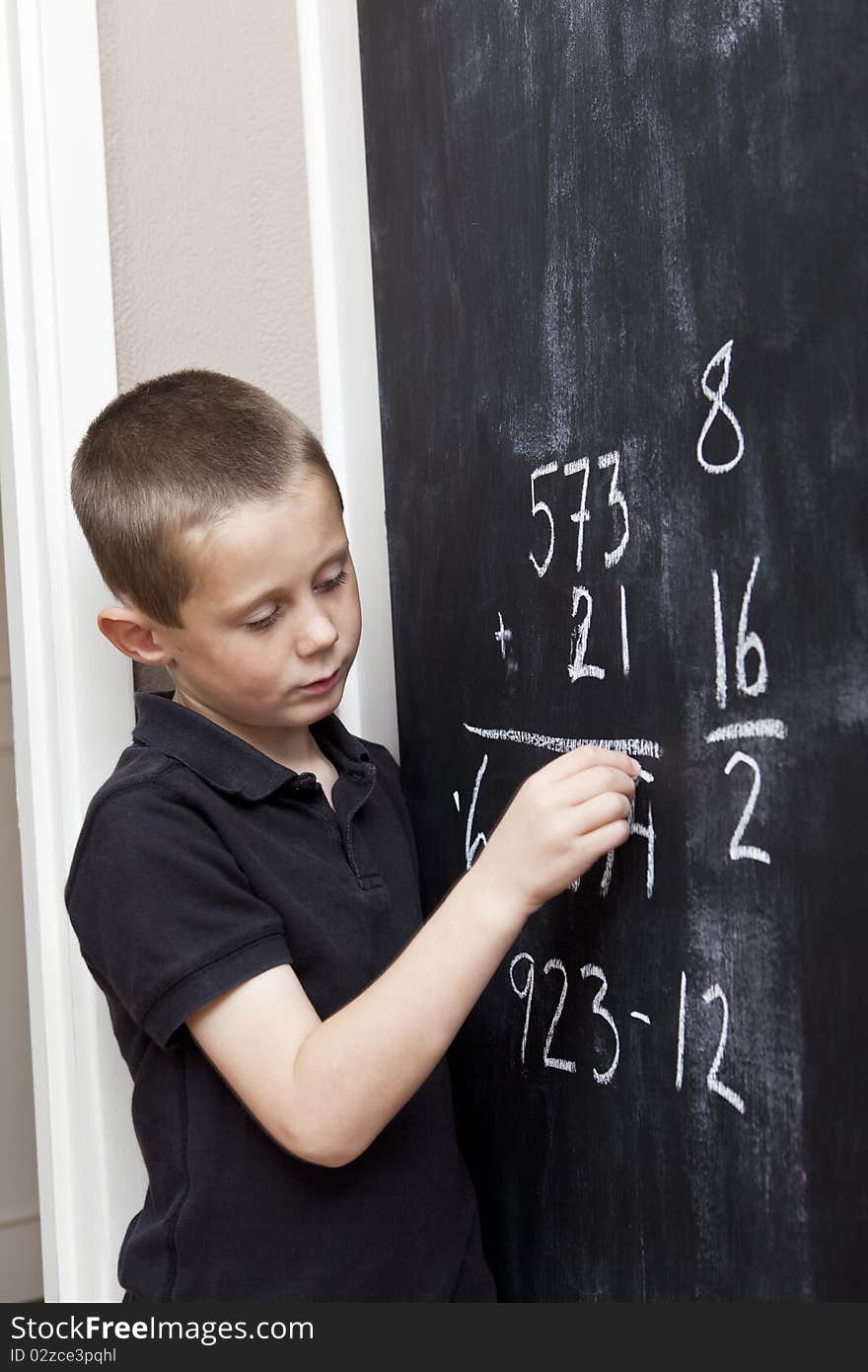 Young Boy in front of the blackboard