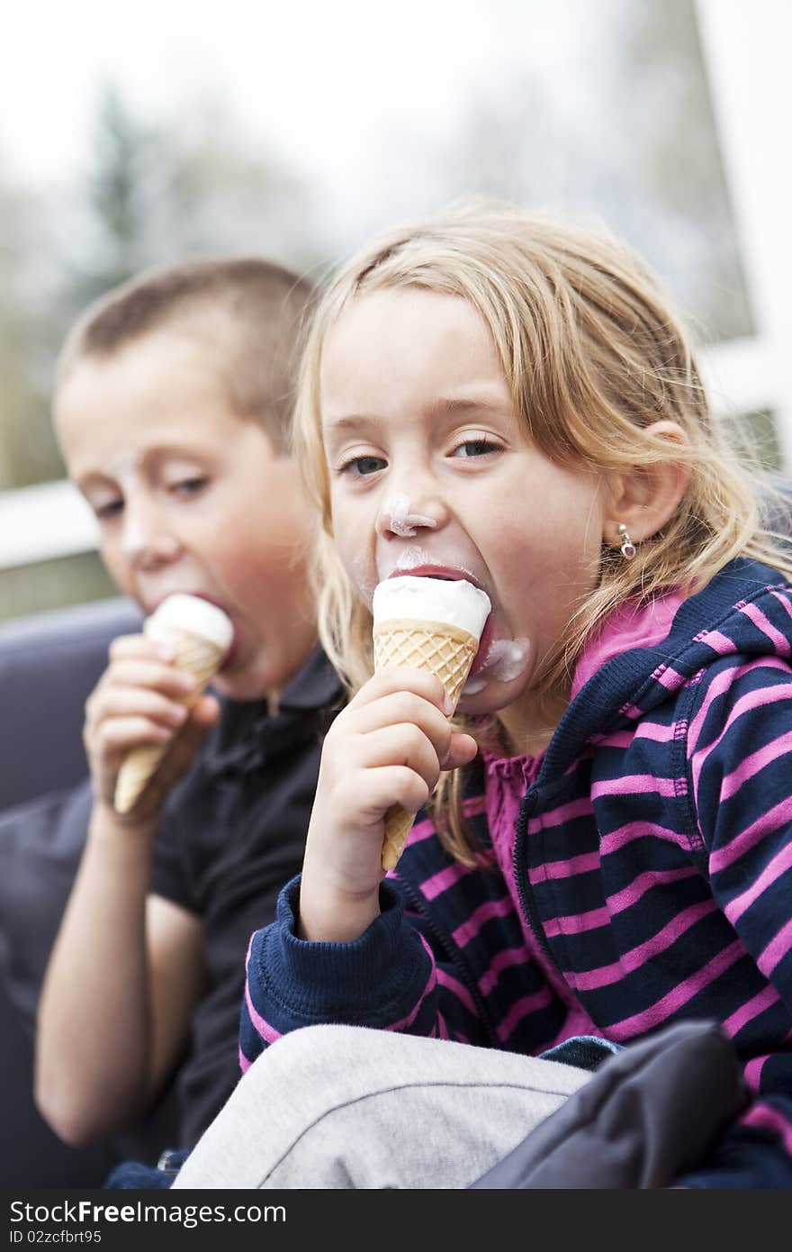 Happy siblings eating ice-cream