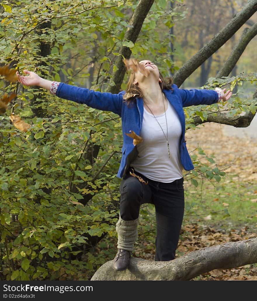 Woman in the autumn forest, playing with leaves. Woman in the autumn forest, playing with leaves