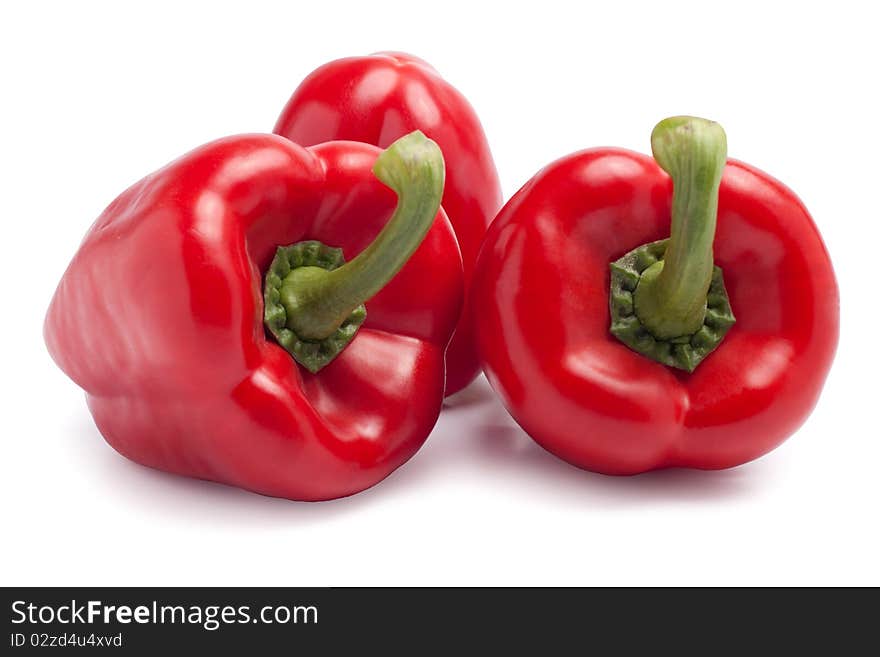 Red paprikas on white background