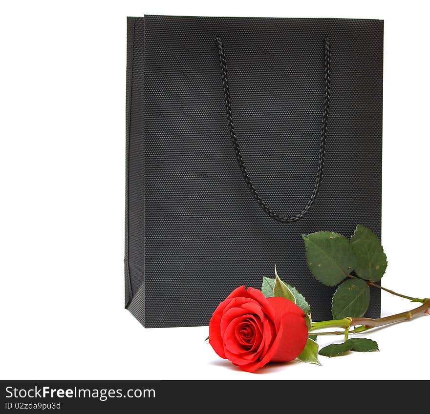 Black bag for a retail shopping experience with red rose. Black bag for a retail shopping experience with red rose