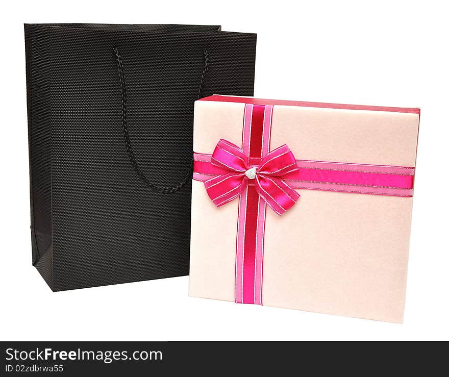 Gift box decorated with ribbon and black bag