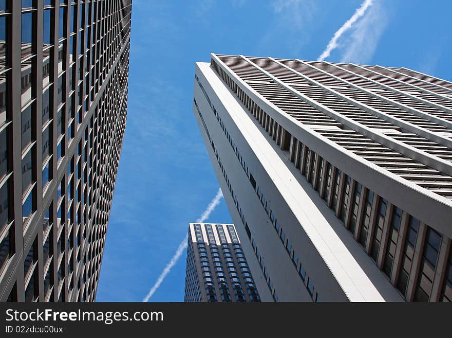 Looking up at tall skyscrapers in a downtown district