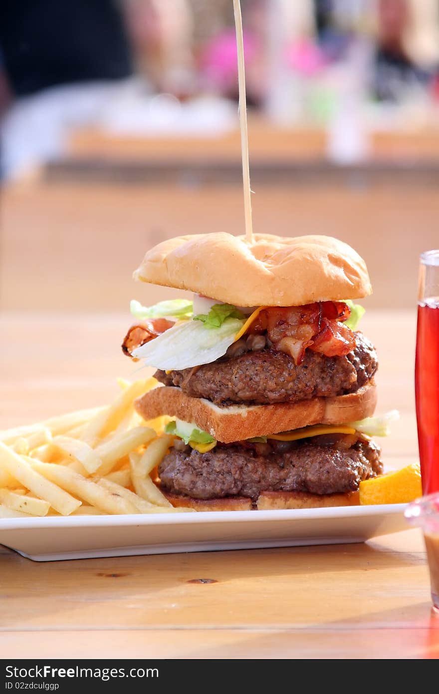 Huge size double cheeseburger with bacon and fries