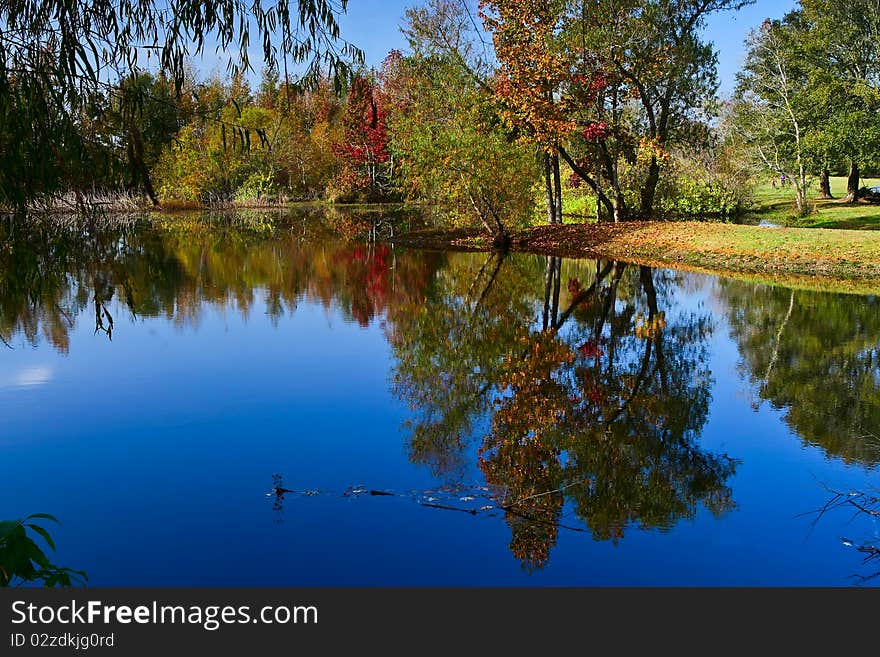 Peaceful fall scene of colorful trees and lake. Peaceful fall scene of colorful trees and lake.