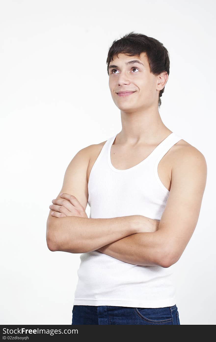 Closeup of a handsome young teenaged guy looking away in thought isolated on white