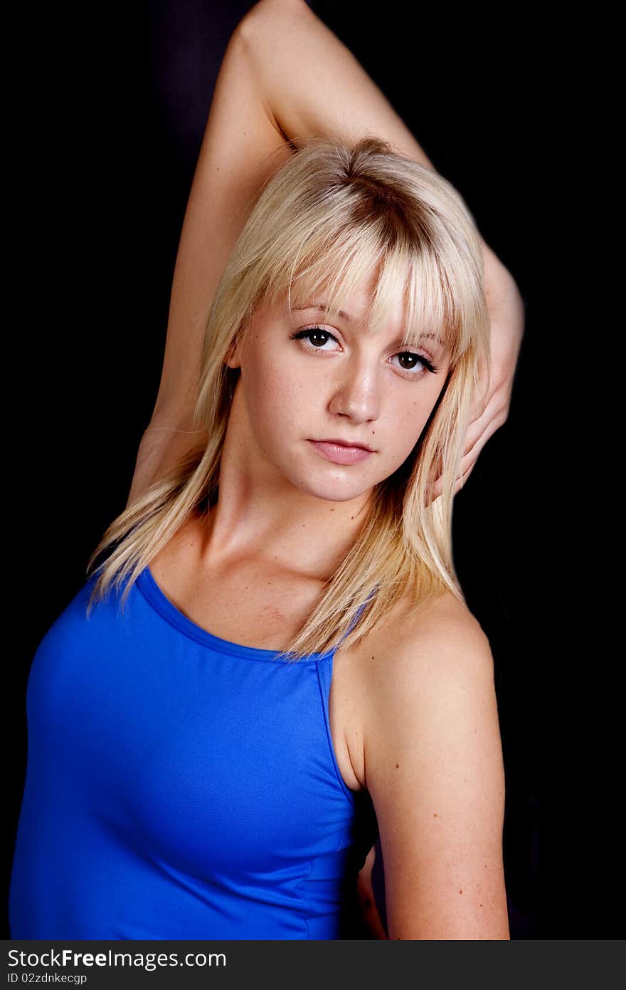 A woman posing in her dance outfit with a serious expression on her face. A woman posing in her dance outfit with a serious expression on her face.