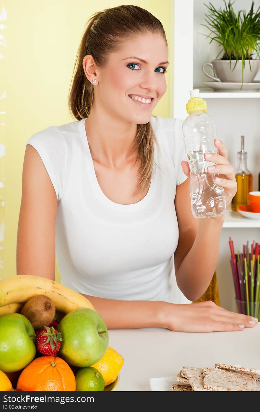 Beauty, young girl holding a bottle of water and smiling