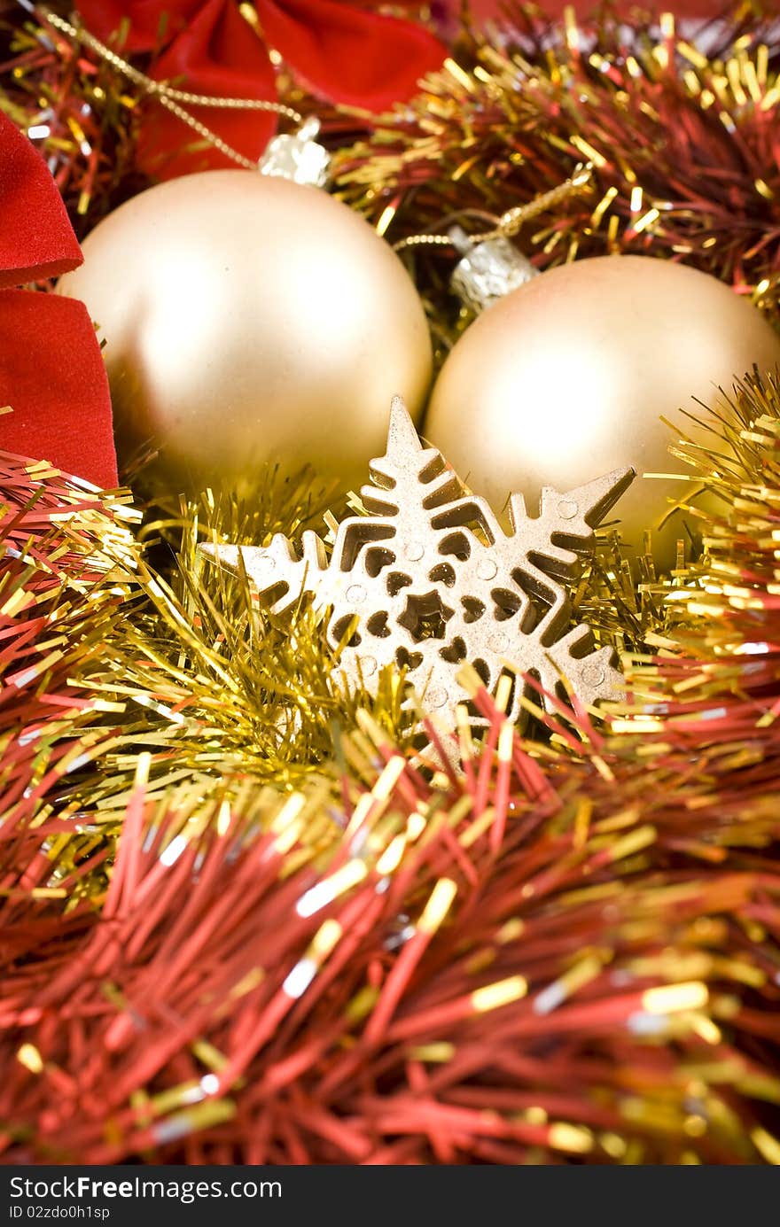 Christmas baubles and ribbons on red background