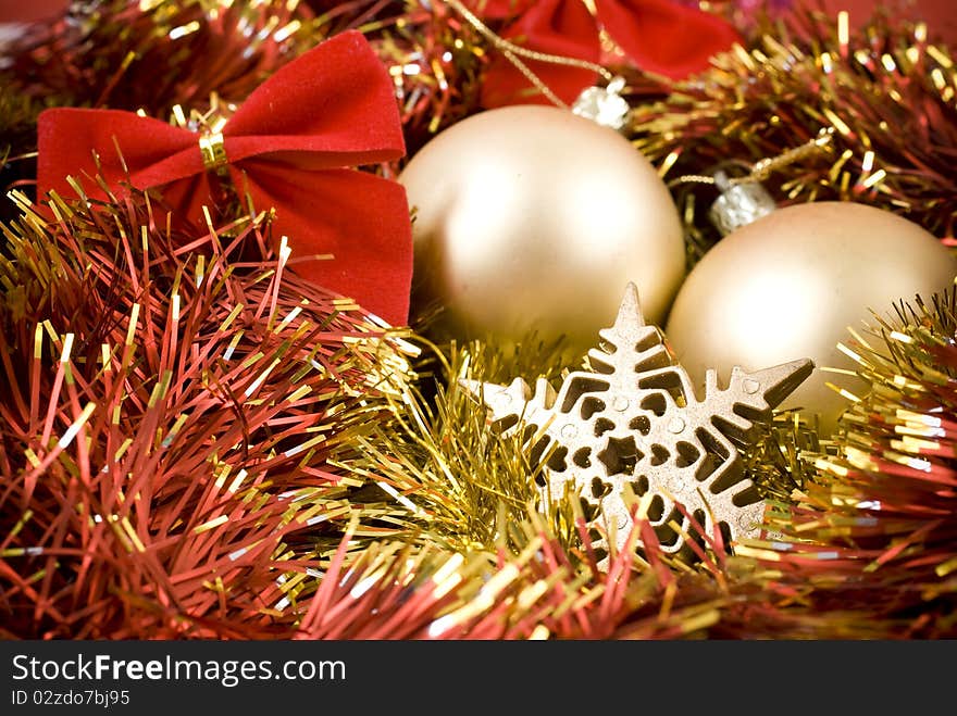 Christmas baubles and ribbons on red background