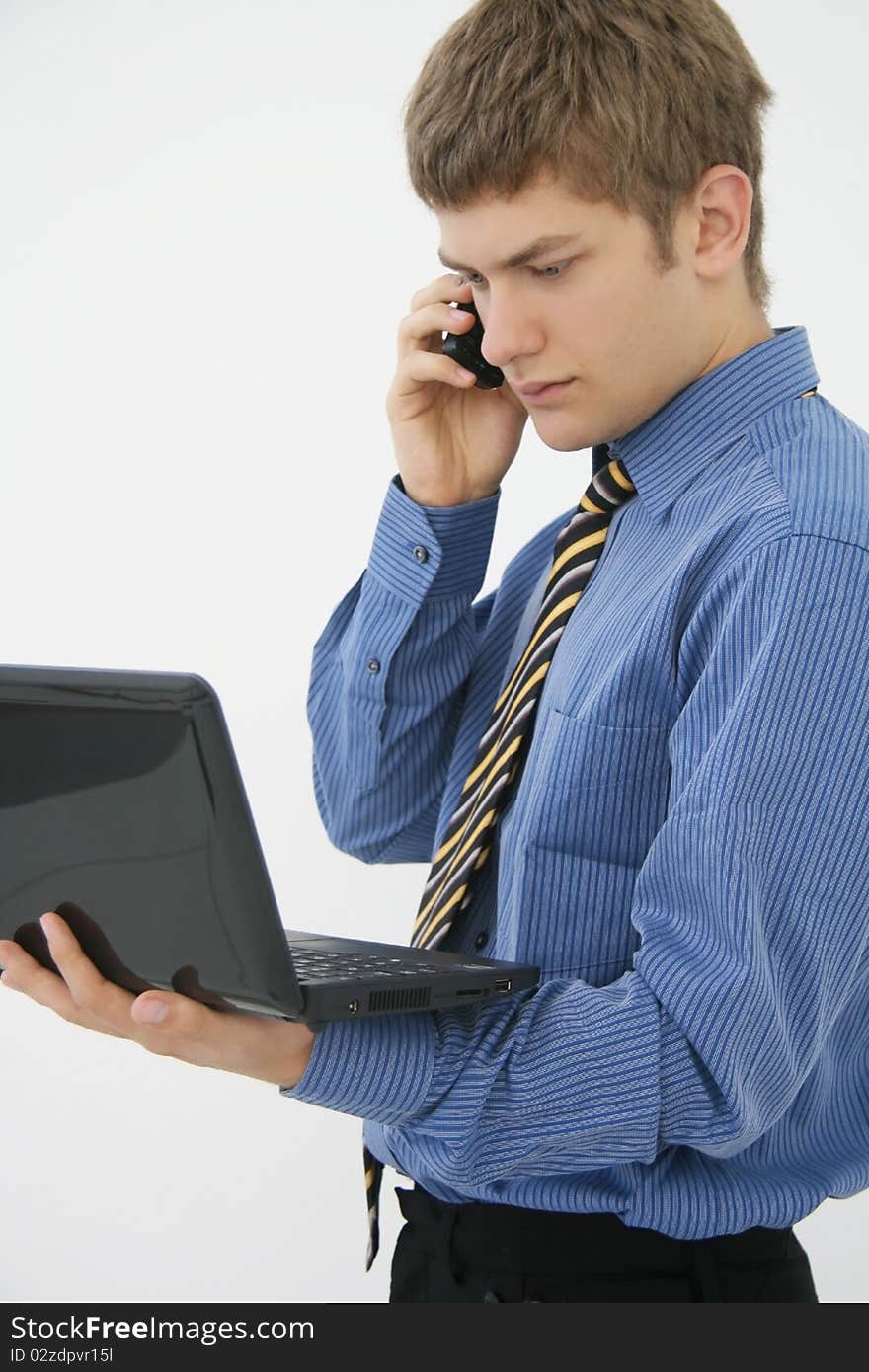 Portrait of a young businessman with phone and notebook