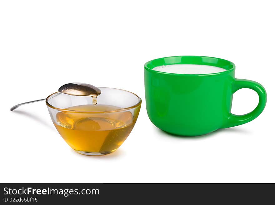 Cup of honey and milk cup on a white background. Cup of honey and milk cup on a white background