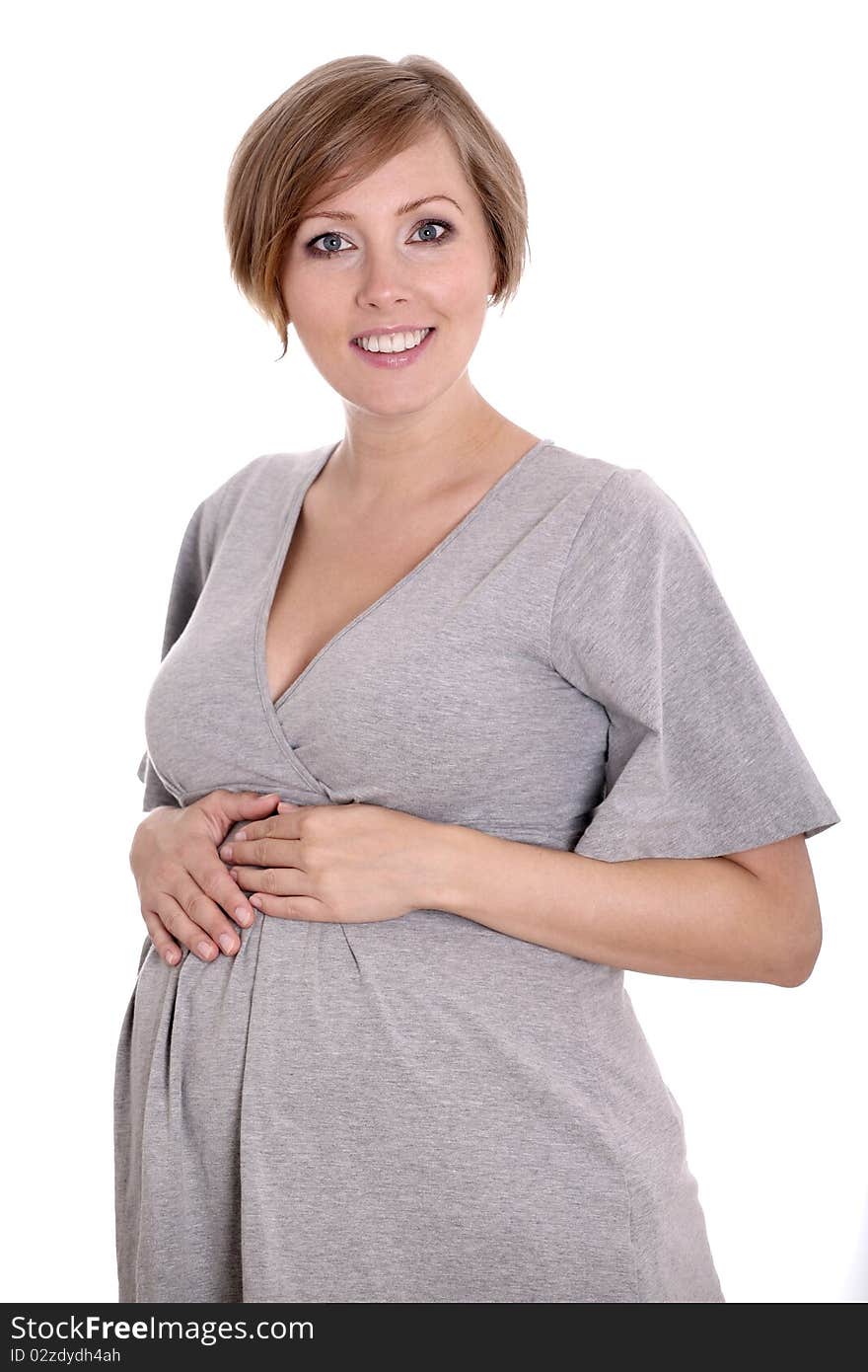 Young pregnant woman in a studio setting isolated over white.