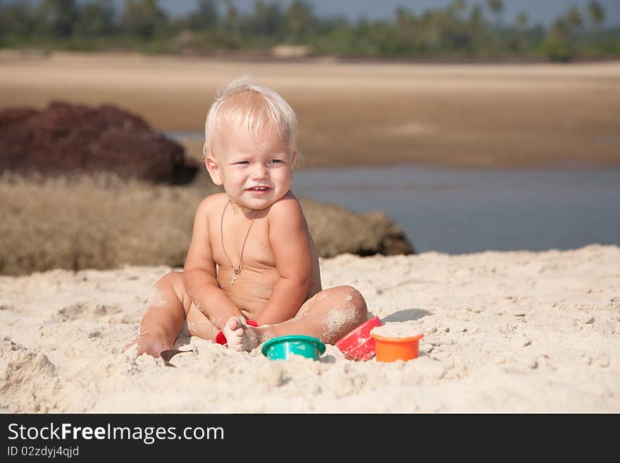 Baby playing on the sea coast