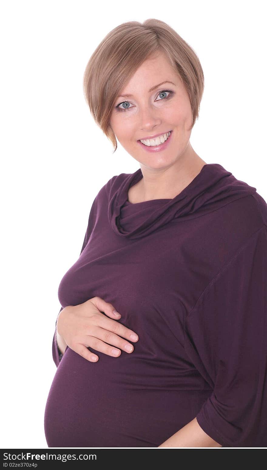 Young pregnant woman in a studio setting isolated over white.