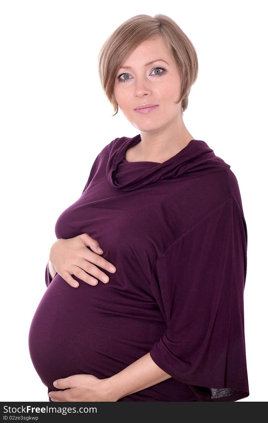 Young pregnant woman in a studio setting isolated over white.