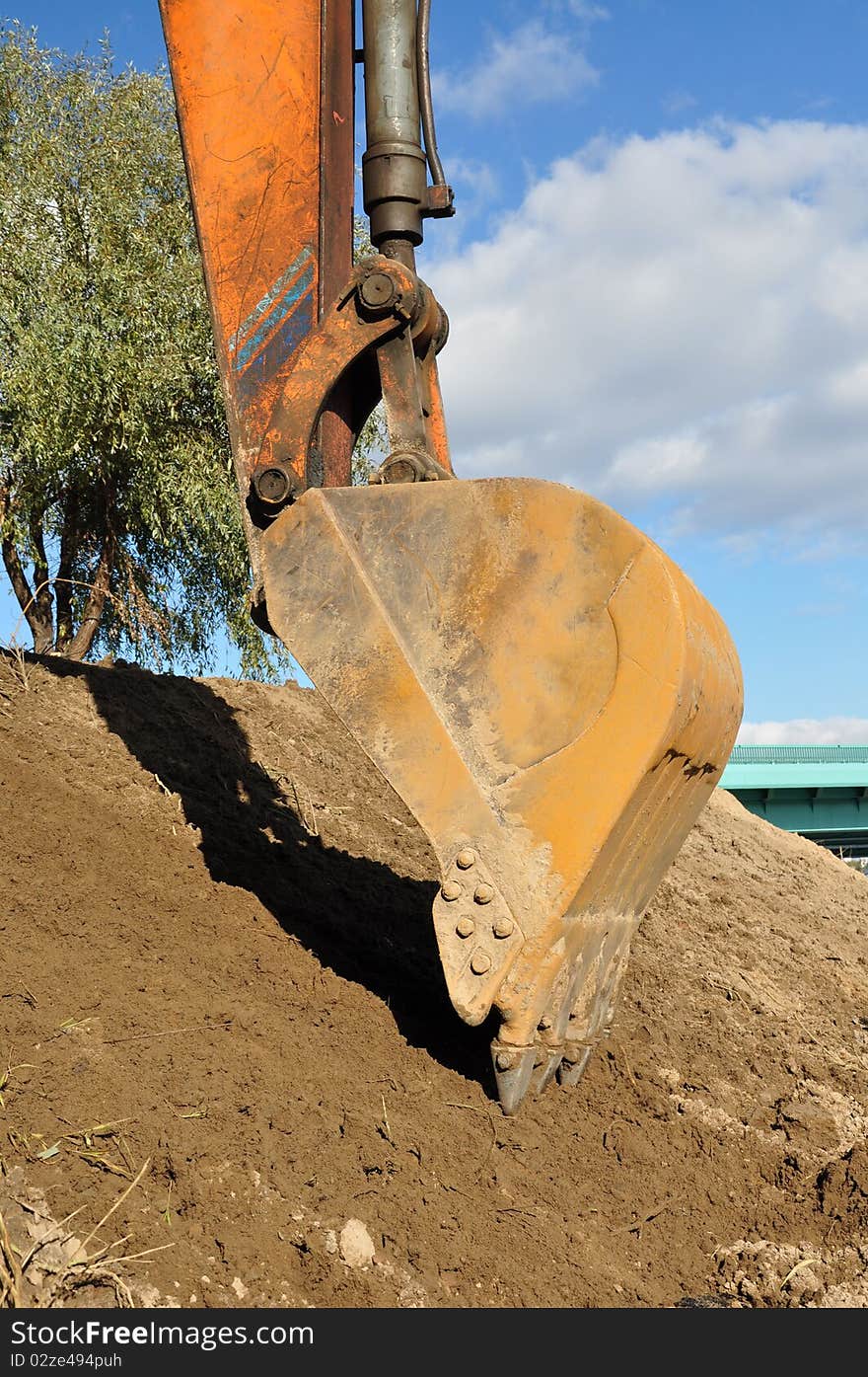 Bucket excavator to dig a hole. Summer. Bucket excavator to dig a hole. Summer.