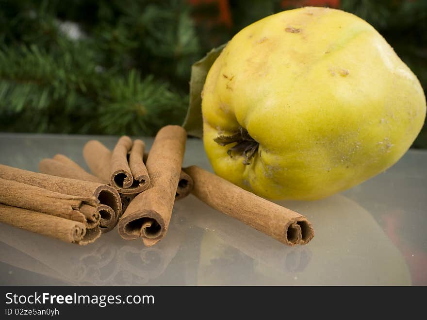 Cinnamon and apples on glass table