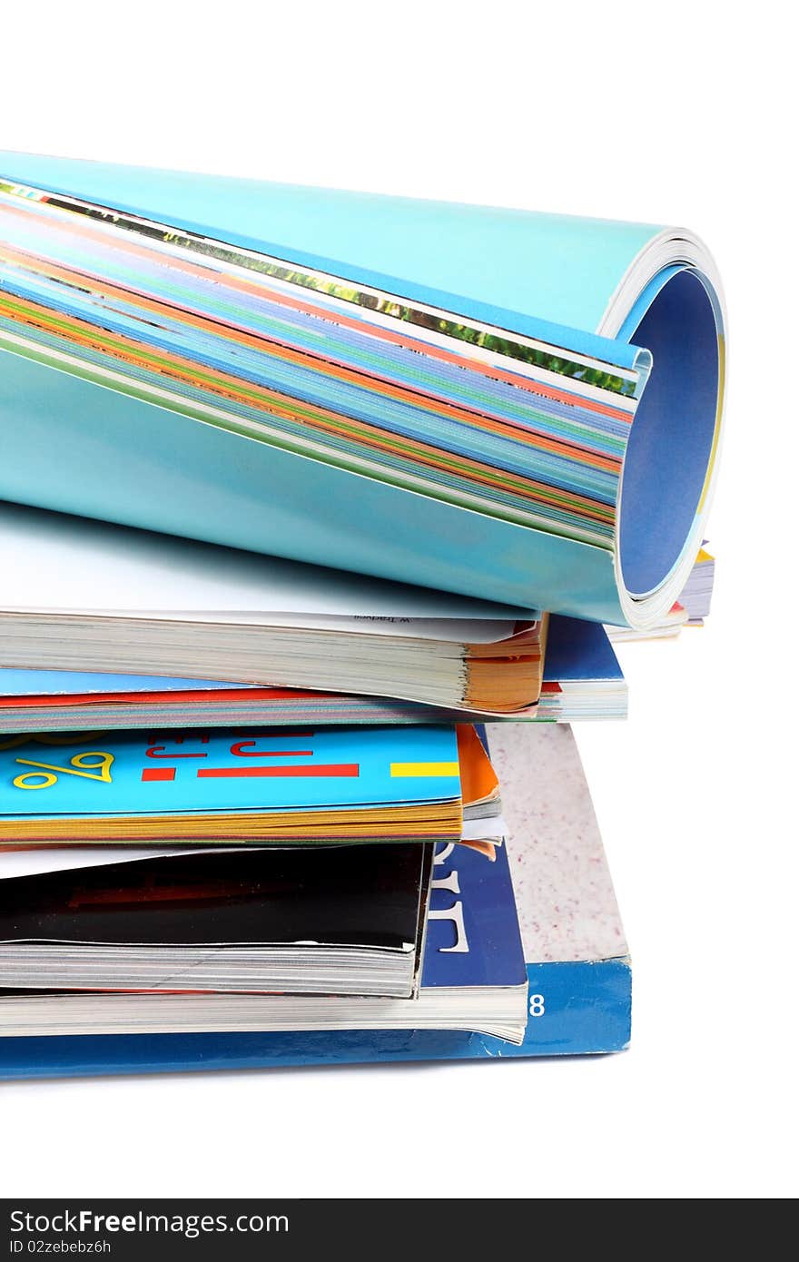 A pile of magazines on white background