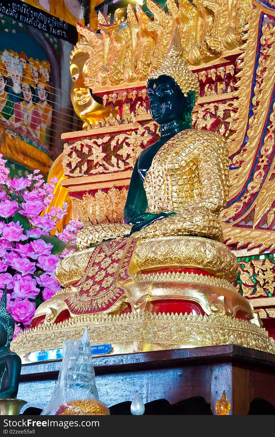 Transparent green Buddha in church at Wat Kaotulian temple, Thailand.