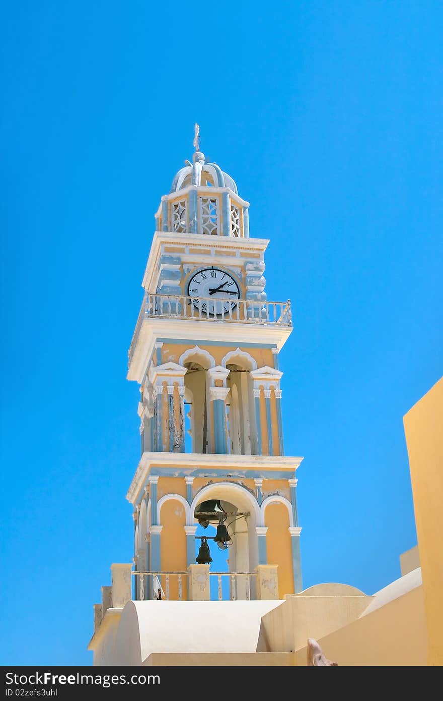 High church tower with clocks and also balcony and cross of top of this. Island of Santorini, Fira, Greece. High church tower with clocks and also balcony and cross of top of this. Island of Santorini, Fira, Greece.