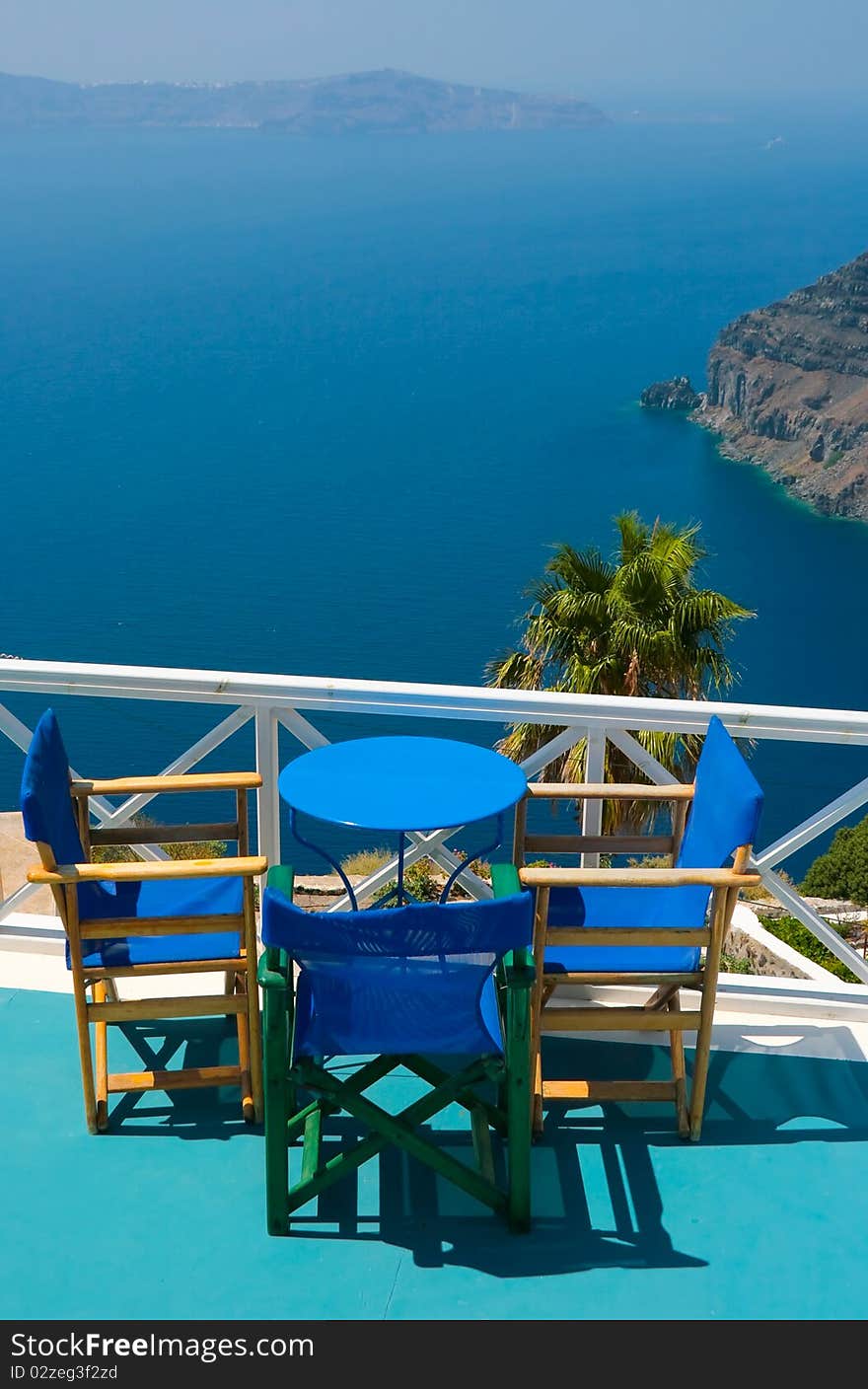 Blue chairs and table in Santorini