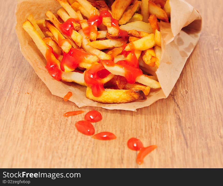 French fries in a paper bag fallen
on the table