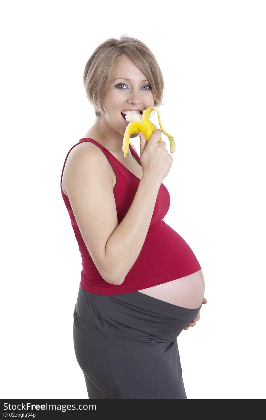 Photo of pregnant woman eating banana