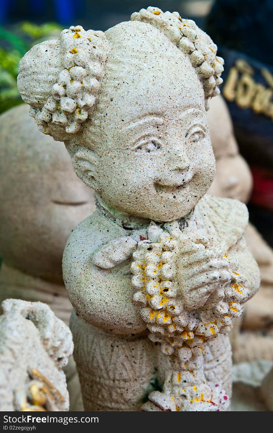 Little girl statue in the garden, Thailand.