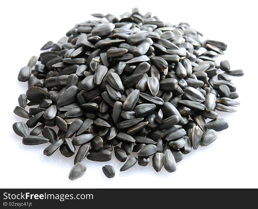 Small pile of sunflower seeds isolated on white background.