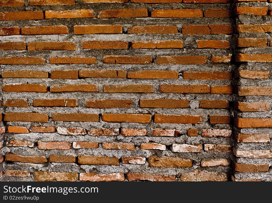 An orange brick wall of an old building in Laoag, Philippines. This type of architecture is now very rare in a world of concrete and metal. An orange brick wall of an old building in Laoag, Philippines. This type of architecture is now very rare in a world of concrete and metal.