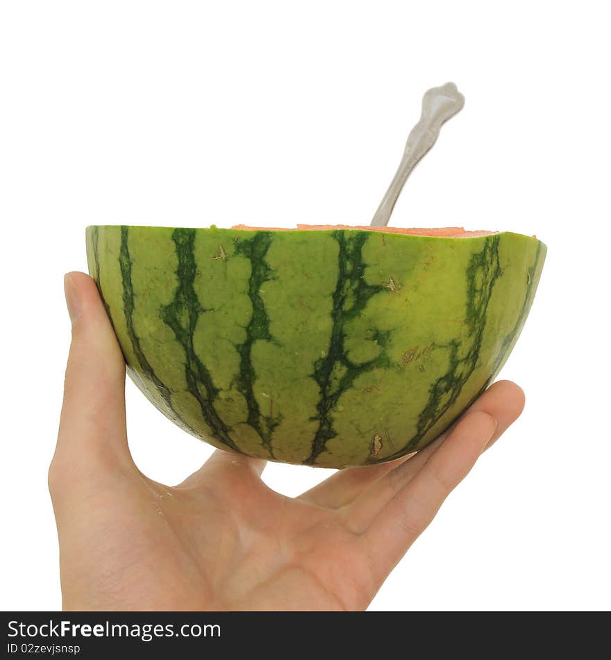 Hand holding a cut watermelon with a spoon. Hand holding a cut watermelon with a spoon