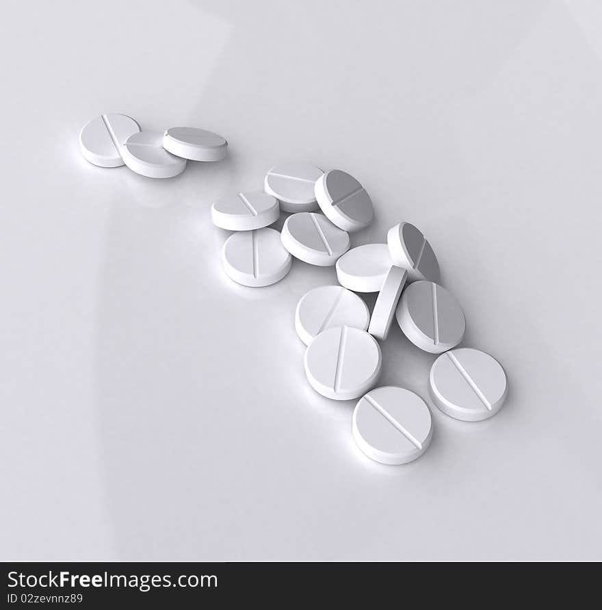 Handful of white tablets on gray