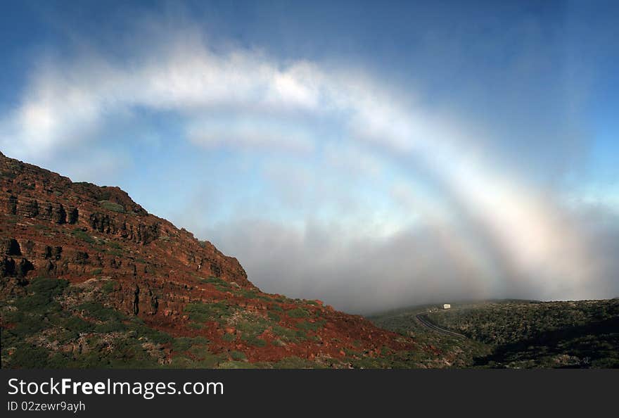 A kind of rainbow that forms in the clouds, in the top of the volcanic island La Palma, Canary islands. A kind of rainbow that forms in the clouds, in the top of the volcanic island La Palma, Canary islands.