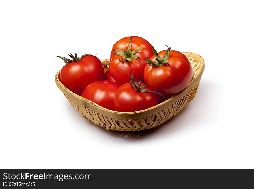 Fresh tomato in a basket isolated on white background. Fresh tomato in a basket isolated on white background