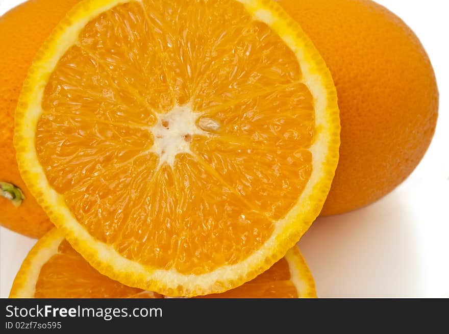 Close up capturing a selection of whole and halved fresh oranges over white. Close up capturing a selection of whole and halved fresh oranges over white.