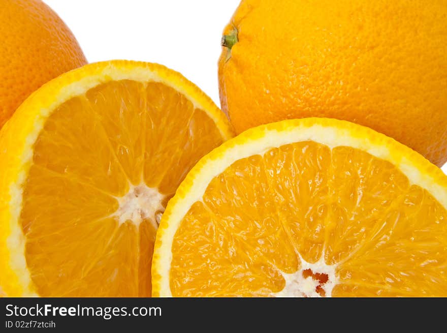 Close up of whole and cut oranges arranged over white. Close up of whole and cut oranges arranged over white.