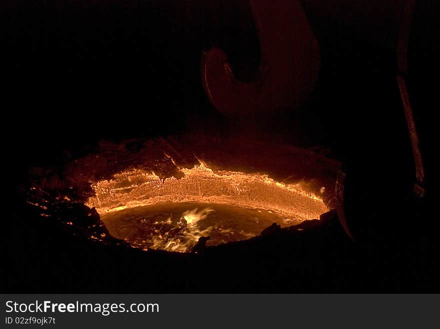 Melted steel in pot, inside steel factory. Melted steel in pot, inside steel factory