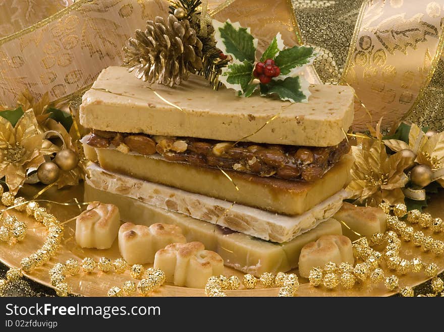 Typical Spanish Christmas nougat in a golden plate