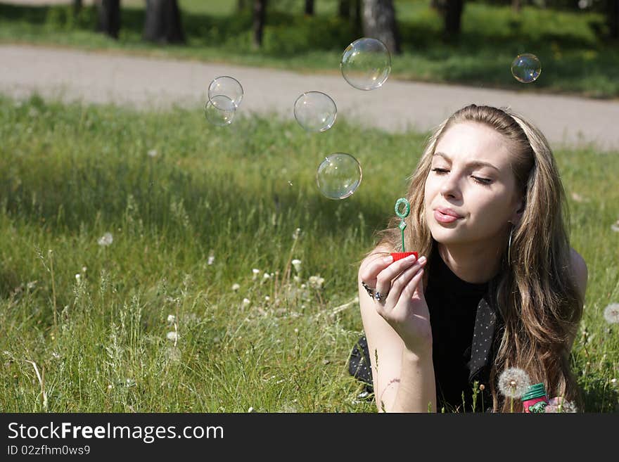 Girl blowing soap bubbles