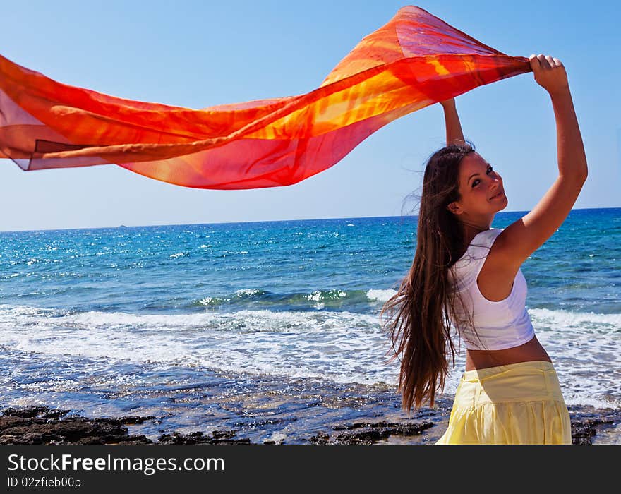 A woman with the pareo is on a coast