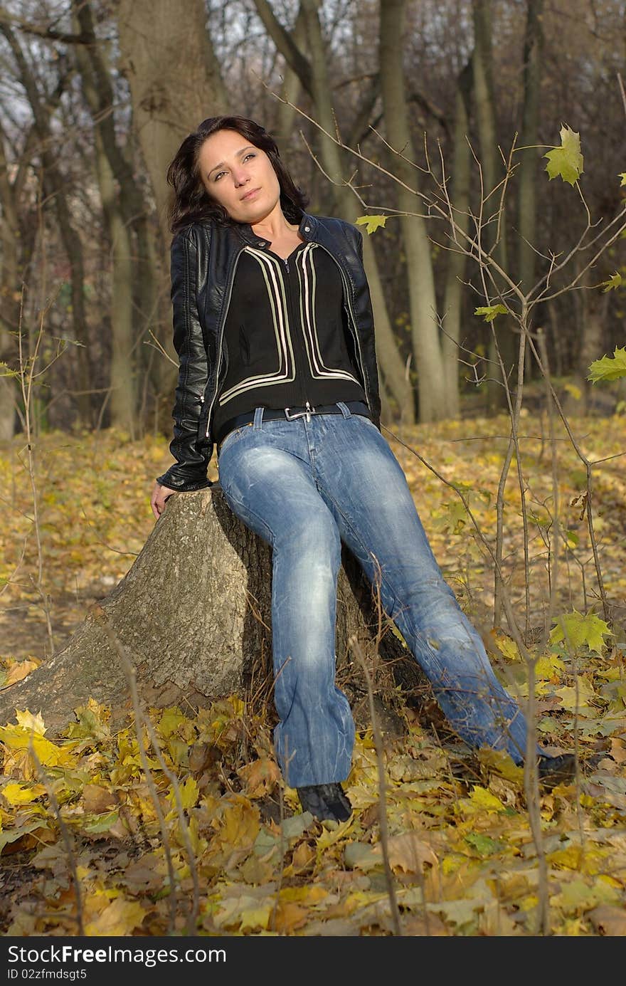 Girl sitting on a tree stump. Girl sitting on a tree stump